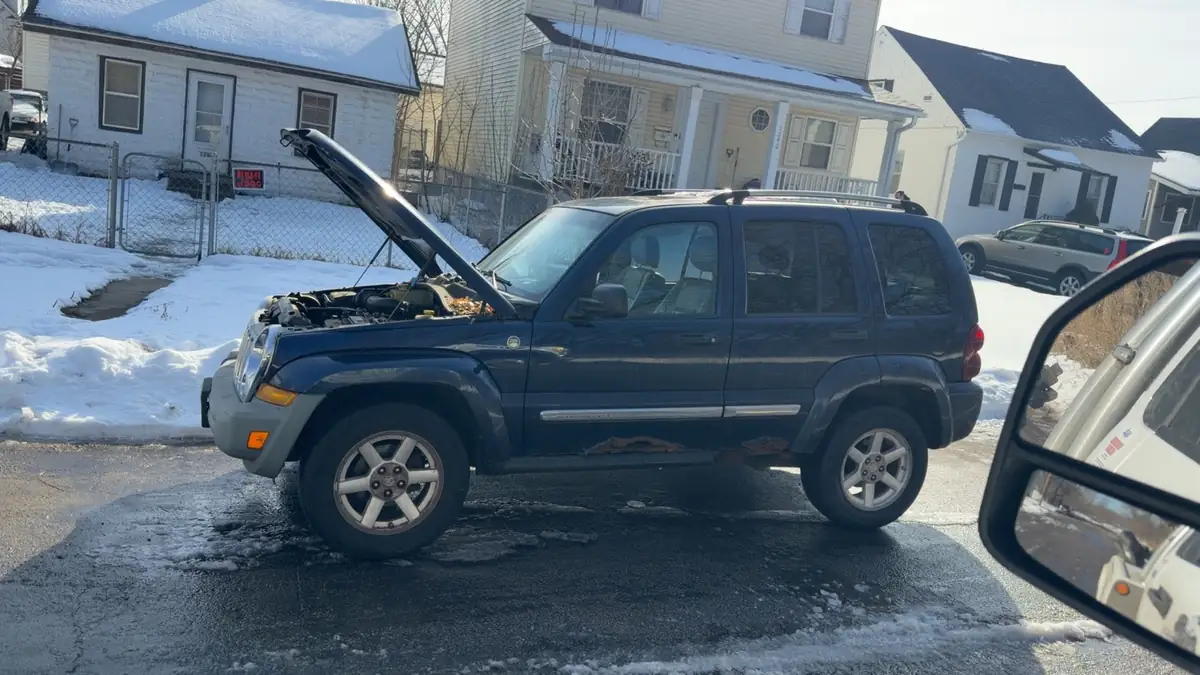 Vehicle awaiting winter roadside assistance in snowy Minneapolis conditions