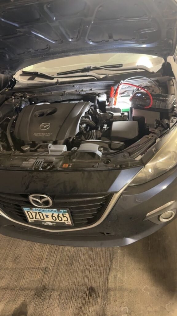 Portable battery booster connected for a mobile jump-start service
