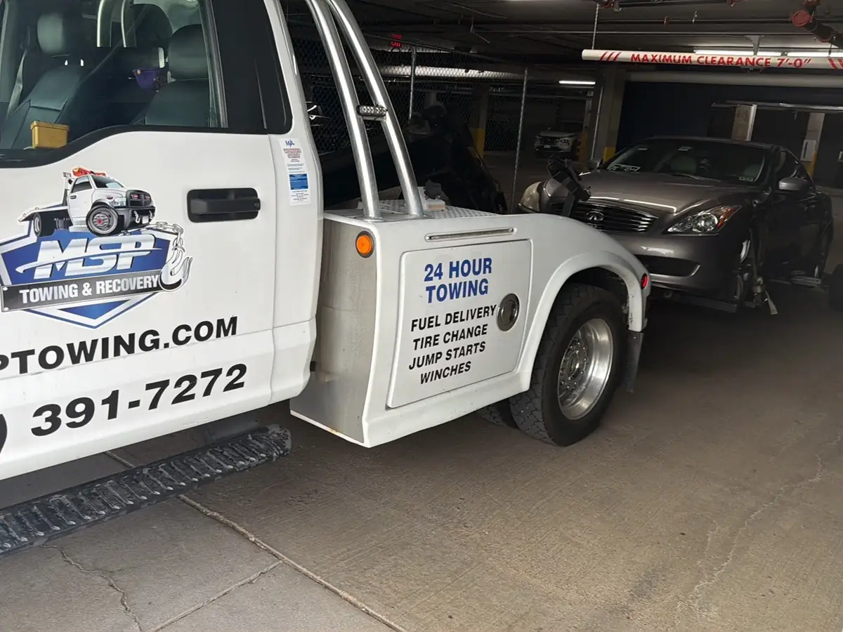 MSP Towing wheel-lift truck positioned inside a Dinkytown parking garage