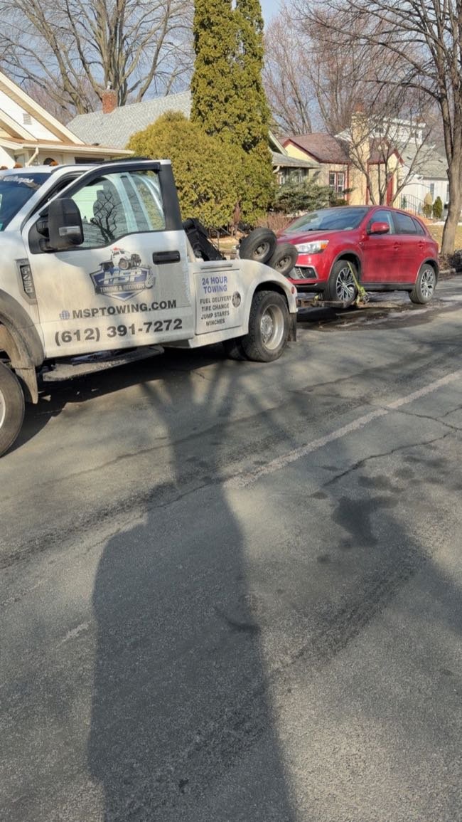 MSP Towing & Recovery loading a red SUV in Uptown Minneapolis